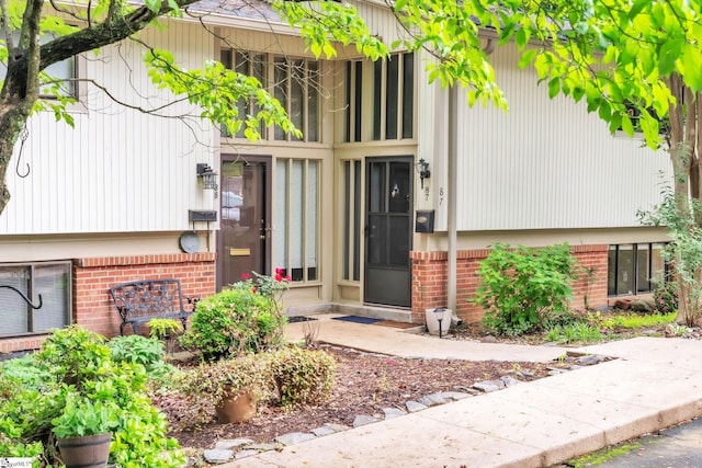 property entrance featuring brick siding