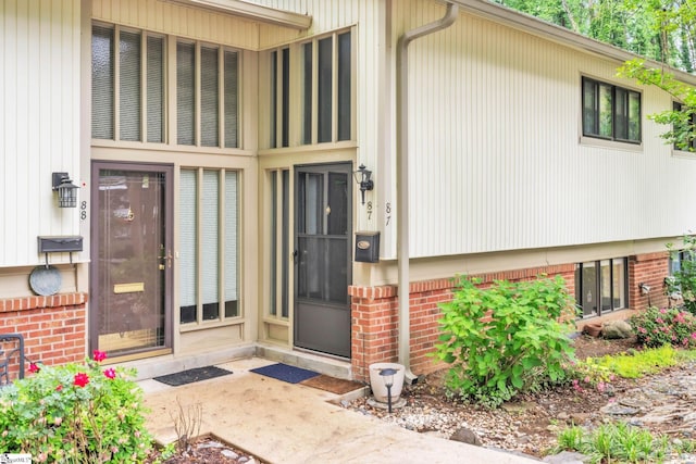 property entrance with brick siding