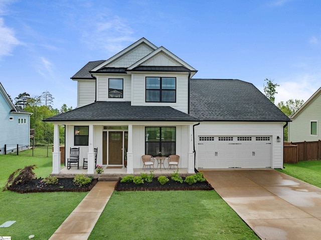 313 Glendon St, Greer, SC 29651 - view of front of house featuring fence, board and batten siding, a porch, and an attached garage