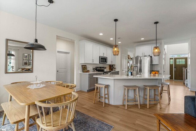 313 Glendon St, Greer, SC 29651 - kitchen featuring light wood-style flooring, appliances with stainless steel finishes, an island with sink, and light countertops