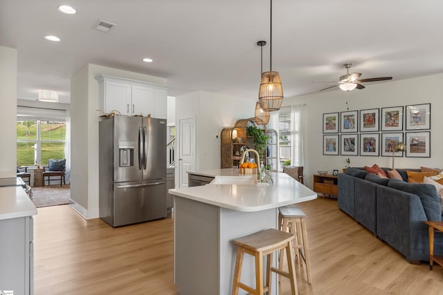 313 Glendon St, Greer, SC 29651 - kitchen with light countertops, a sink, light wood-type flooring, stainless steel refrigerator with ice dispenser, and a ceiling fan