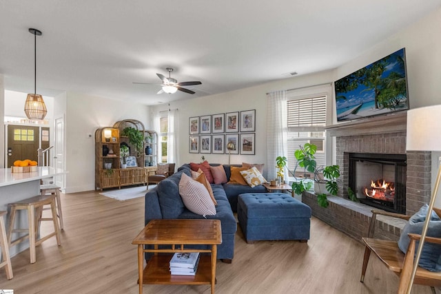 313 Glendon St, Greer, SC 29651 - living room with plenty of natural light, light wood-style flooring, a ceiling fan, and a brick fireplace
