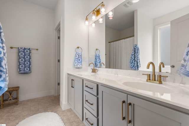 313 Glendon St, Greer, SC 29651 - bathroom with baseboards, visible vents, double vanity, and a sink
