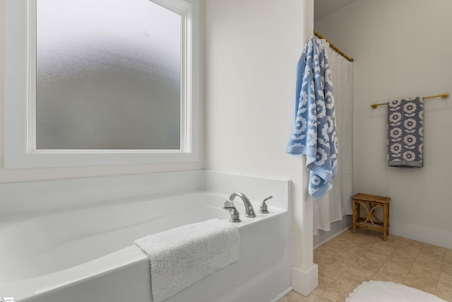 313 Glendon St, Greer, SC 29651 - bathroom with a wealth of natural light, a bath, and baseboards
