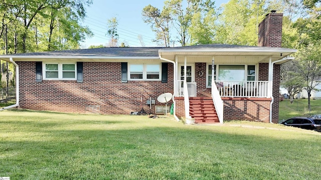 ranch-style home featuring a chimney, brick siding, covered porch, and a front lawn
