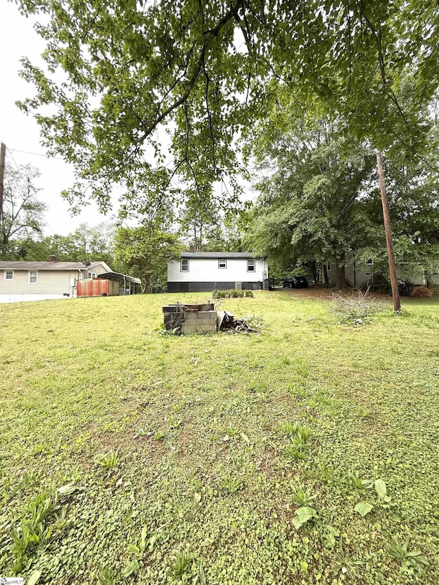view of yard with an outdoor fire pit