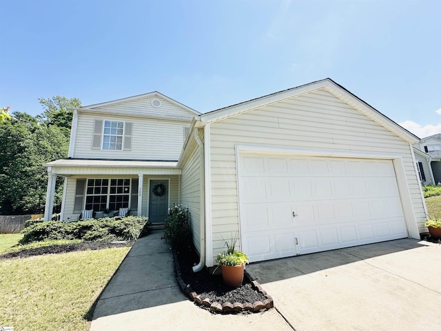 view of front of house with a garage, concrete driveway, a porch, and a front lawn