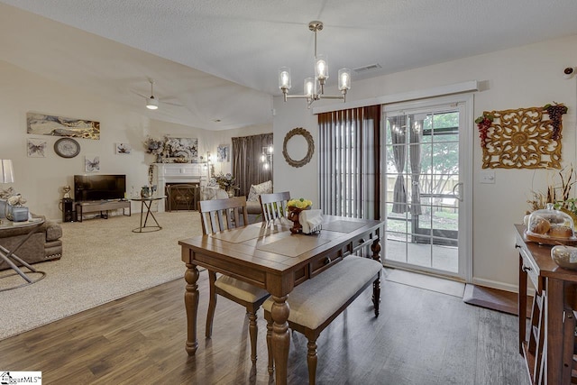 3 Heatherfield Dr, Simpsonville, SC 29680 - dining area featuring ceiling fan with notable chandelier, visible vents, wood finished floors, and a fireplace