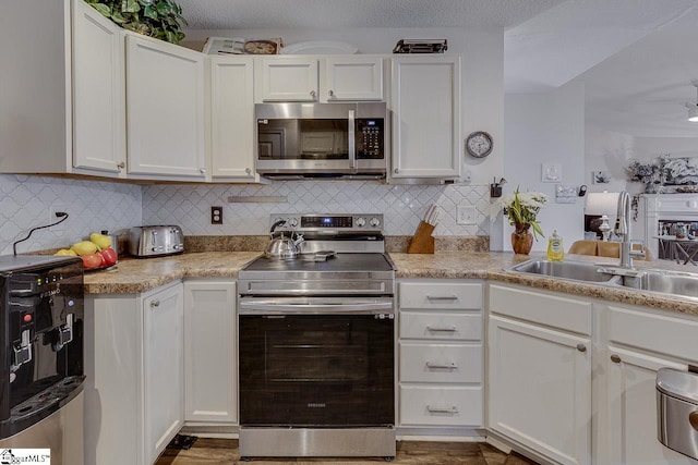 3 Heatherfield Dr, Simpsonville, SC 29680 - kitchen featuring decorative backsplash, appliances with stainless steel finishes, light countertops, white cabinets, and a sink