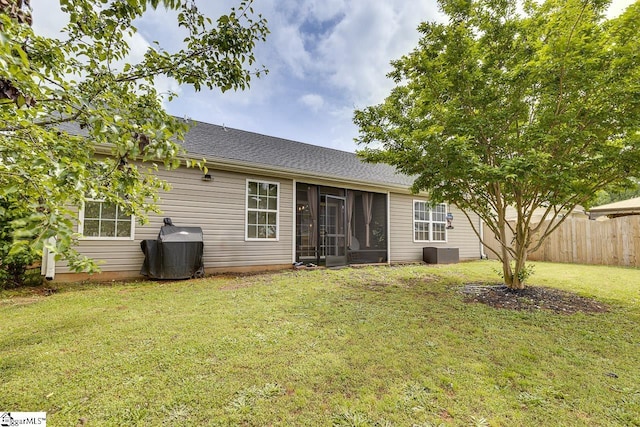 3 Heatherfield Dr, Simpsonville, SC 29680 - rear view of house with a sunroom, a lawn, central AC, roof with shingles, and fence
