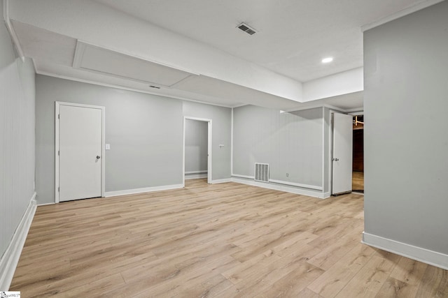 spare room with baseboards, visible vents, and light wood finished floors