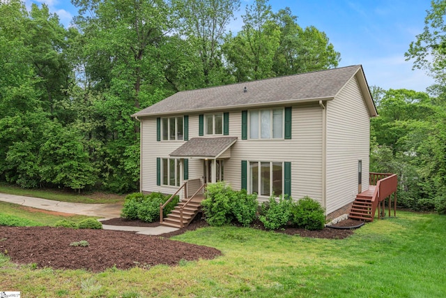 colonial house with roof with shingles and a front yard