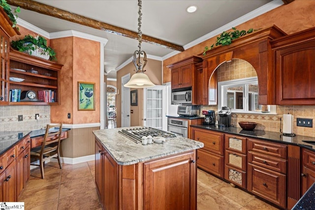 kitchen featuring dark stone countertops, stainless steel appliances, decorative light fixtures, a kitchen island, and backsplash