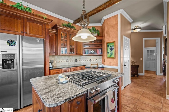 kitchen with tasteful backsplash, brown cabinets, stainless steel appliances, and a kitchen island