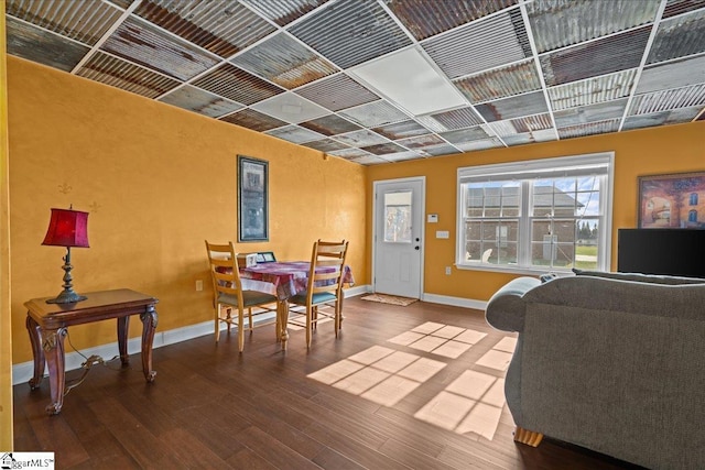 living area with wood finished floors and baseboards