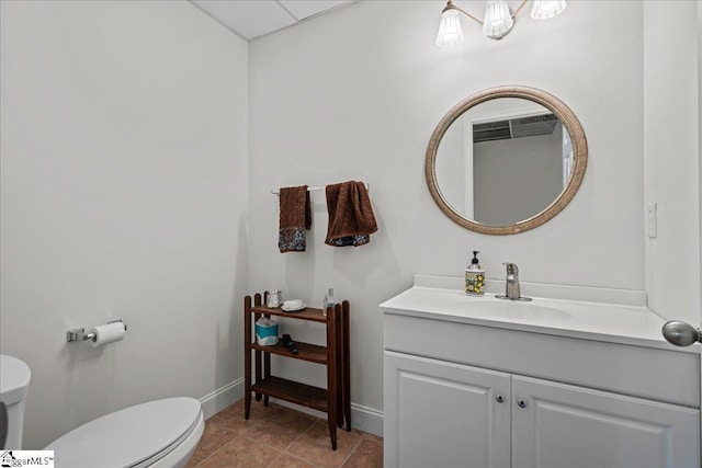 half bath with vanity, toilet, and baseboards