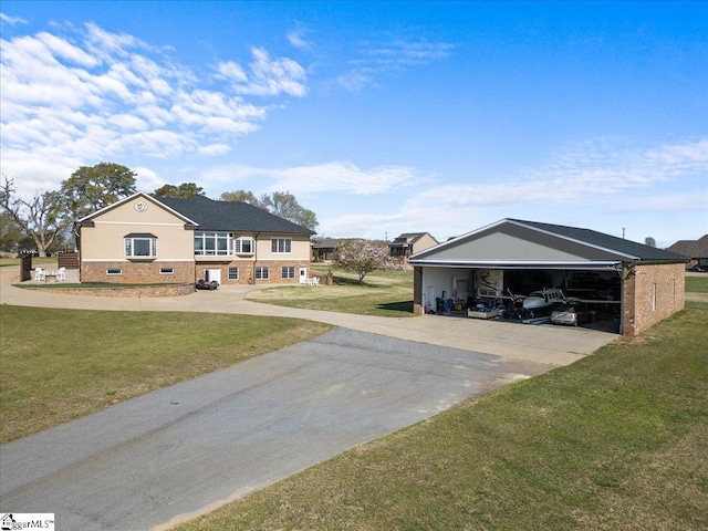 view of yard with a garage and driveway