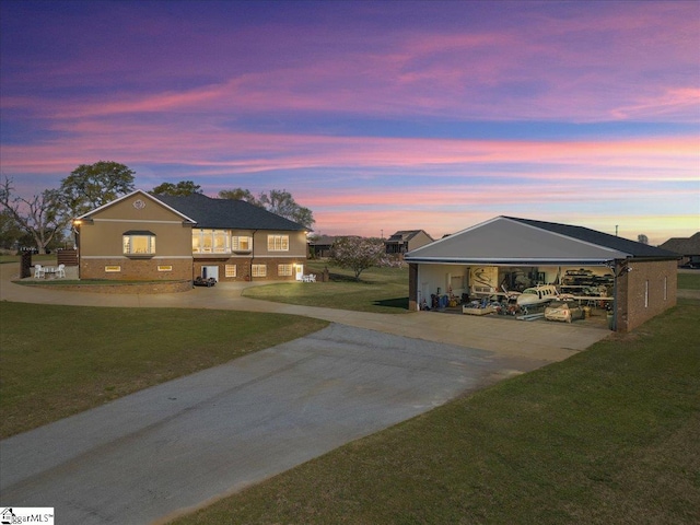 exterior space featuring concrete driveway and a lawn