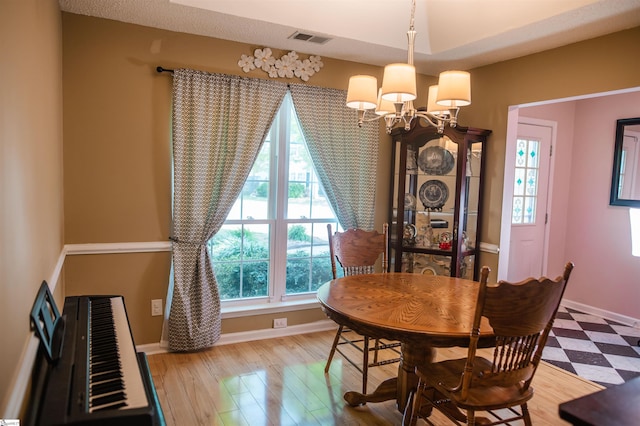 104 Fairview Lake Way, Simpsonville, SC 29680 - dining space with an inviting chandelier, visible vents, wood finished floors, and baseboards