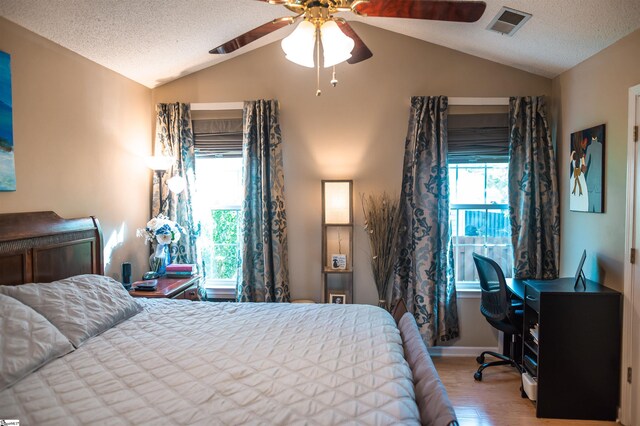 104 Fairview Lake Way, Simpsonville, SC 29680 - bedroom featuring lofted ceiling, a textured ceiling, wood finished floors, and visible vents