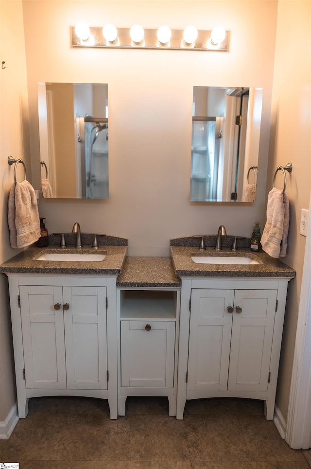 104 Fairview Lake Way, Simpsonville, SC 29680 - full bathroom featuring two vanities, baseboards, and a sink
