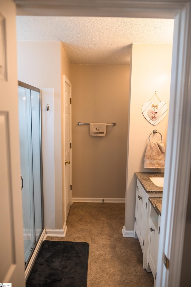 104 Fairview Lake Way, Simpsonville, SC 29680 - full bathroom featuring a textured ceiling, vanity, a stall shower, and baseboards