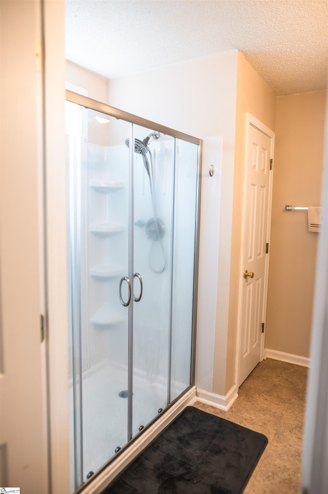 104 Fairview Lake Way, Simpsonville, SC 29680 - bathroom featuring baseboards, a shower stall, and a textured ceiling