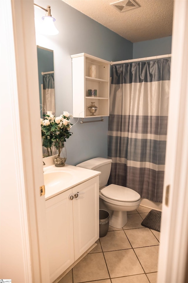 104 Fairview Lake Way, Simpsonville, SC 29680 - full bathroom featuring tile patterned floors, toilet, vanity, visible vents, and a textured ceiling