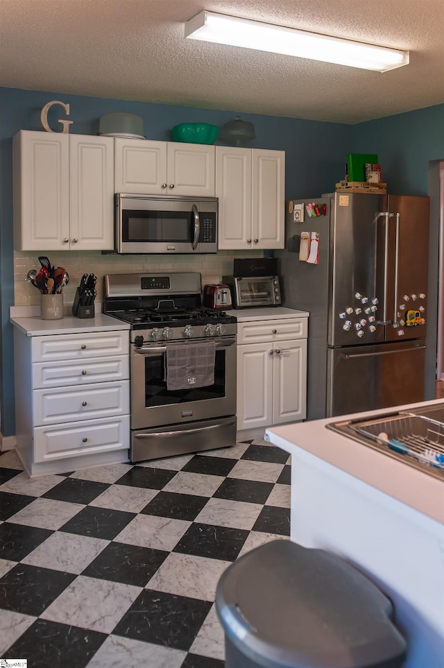 104 Fairview Lake Way, Simpsonville, SC 29680 - kitchen with a textured ceiling, stainless steel appliances, light countertops, and white cabinets