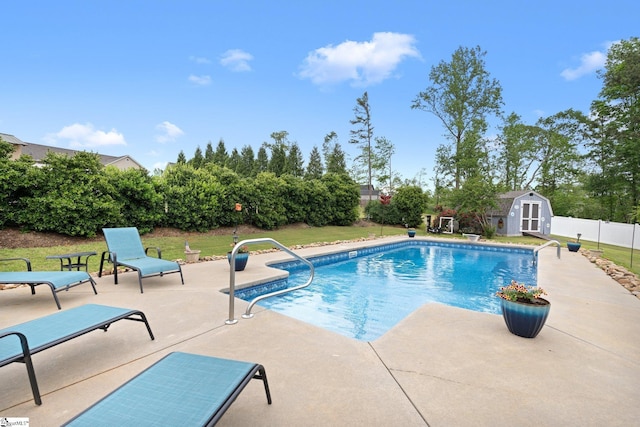 view of pool featuring a patio area, an outbuilding, a fenced in pool, a storage shed, and fence