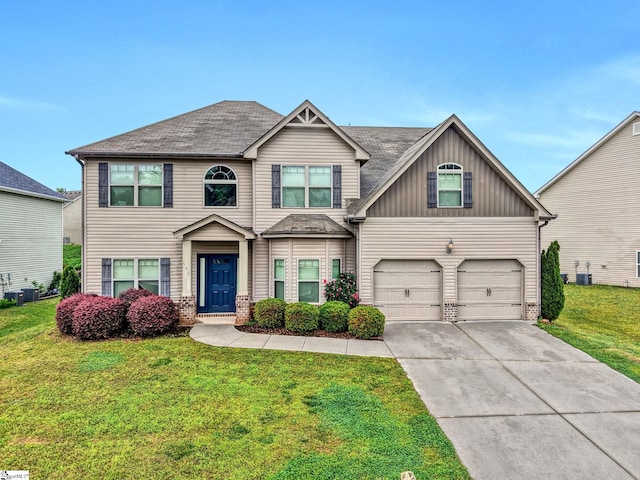 view of front facade featuring driveway, cooling unit, a front yard, and a garage