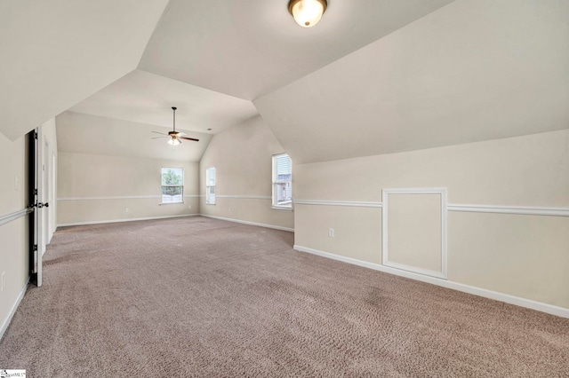 bonus room with lofted ceiling, ceiling fan, carpet flooring, and baseboards