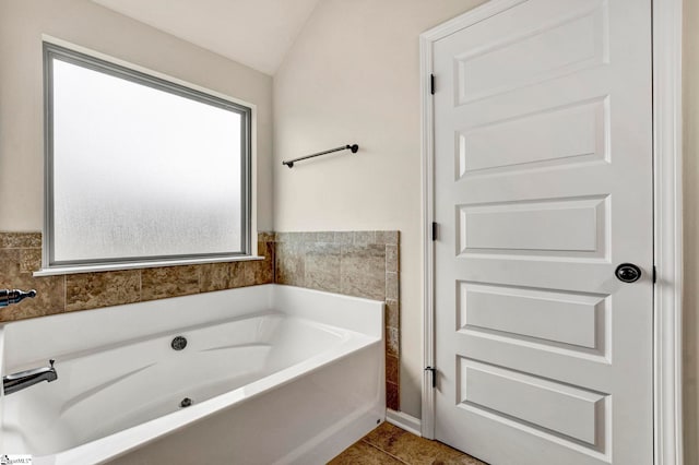 full bath with tile patterned flooring and a bath