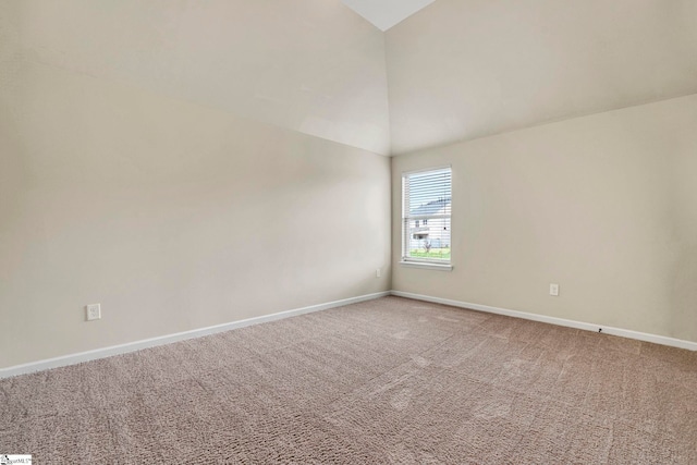 spare room with high vaulted ceiling, carpet, and baseboards