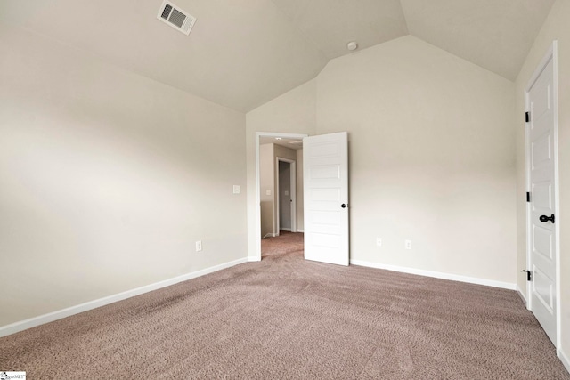 unfurnished bedroom featuring visible vents, baseboards, vaulted ceiling, and carpet floors