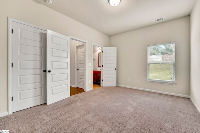 unfurnished bedroom with baseboards, visible vents, and carpet flooring
