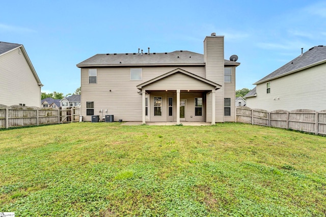 back of property featuring a lawn, a fenced backyard, and a patio area
