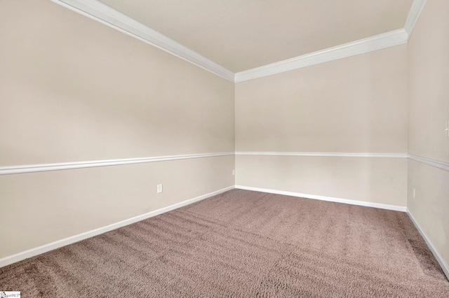empty room featuring ornamental molding, carpet, and baseboards