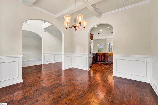 unfurnished dining area with dark wood finished floors, coffered ceiling, a chandelier, wainscoting, and beam ceiling
