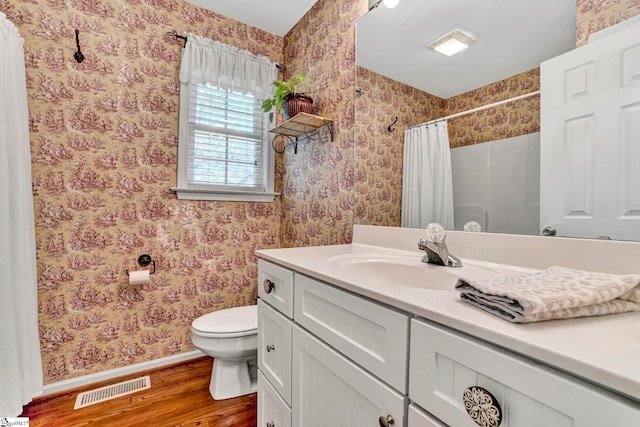 1230 Melton Rd Unit 104, West Union, SC 29696 - full bathroom featuring visible vents, wallpapered walls, baseboards, toilet, and wood finished floors