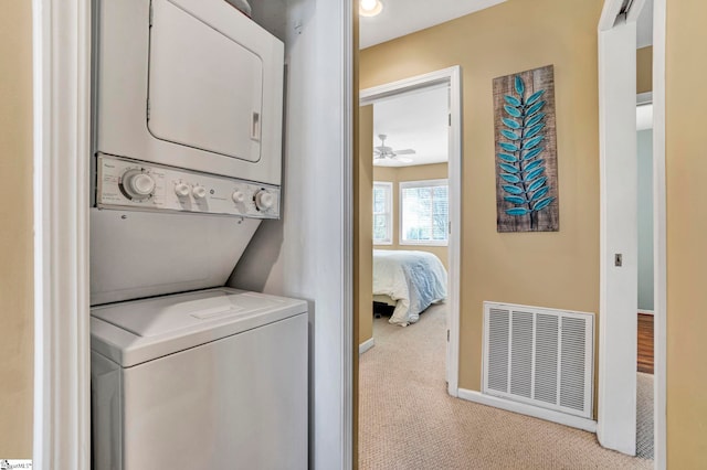 1230 Melton Rd Unit 104, West Union, SC 29696 - laundry room with stacked washer and dryer, visible vents, baseboards, carpet floors, and laundry area