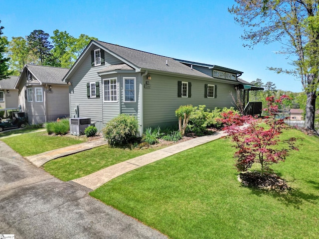 1230 Melton Rd Unit 104, West Union, SC 29696 - view of property exterior featuring a yard, a shingled roof, and central AC