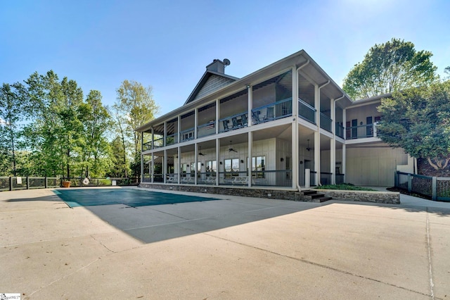 1230 Melton Rd Unit 104, West Union, SC 29696 - back of house with a patio area, a balcony, a fenced in pool, board and batten siding, and a chimney