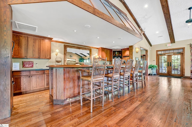 1230 Melton Rd Unit 104, West Union, SC 29696 - kitchen featuring light wood-style floors, lofted ceiling with beams, visible vents, and brown cabinetry