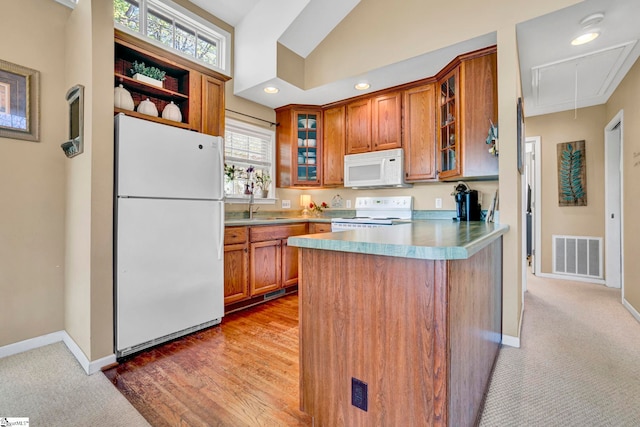 1230 Melton Rd Unit 104, West Union, SC 29696 - kitchen with a sink, brown cabinetry, visible vents, a peninsula, and white appliances