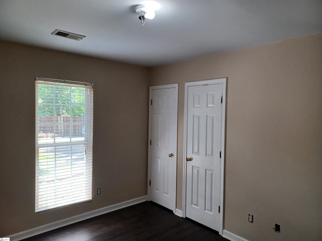 315 Farnsworth Rd, Spartanburg, SC 29301 - unfurnished bedroom with baseboards and dark wood-type flooring