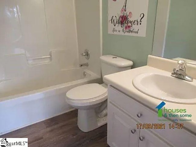 317 Farnsworth Rd, Spartanburg, SC 29301 - bathroom with vanity, wood finished floors, toilet, and tub / shower combination