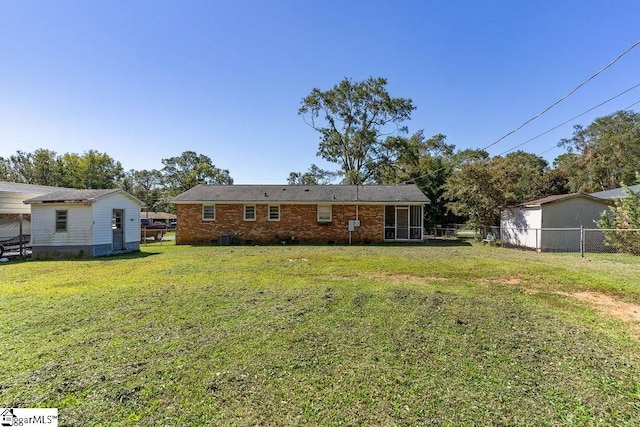 411 Granada Dr, Spartanburg, SC 29303 - back of house with brick siding, fence, and a lawn