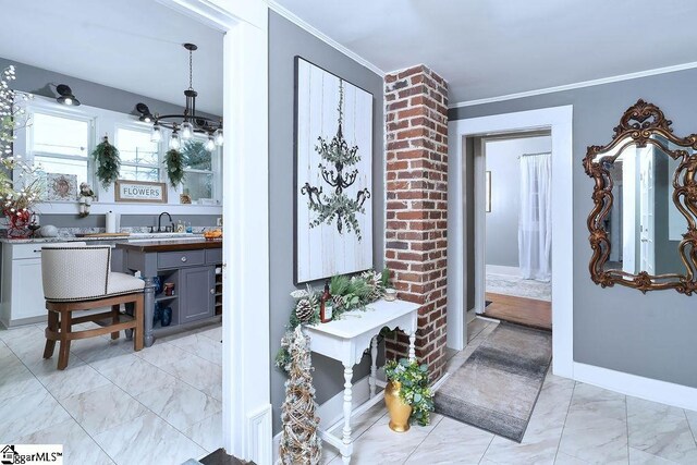 15 S Greenwood Ave, Ware Shoals, SC 29629 - hall with crown molding, a sink, a chandelier, baseboards, and marble finish floor
