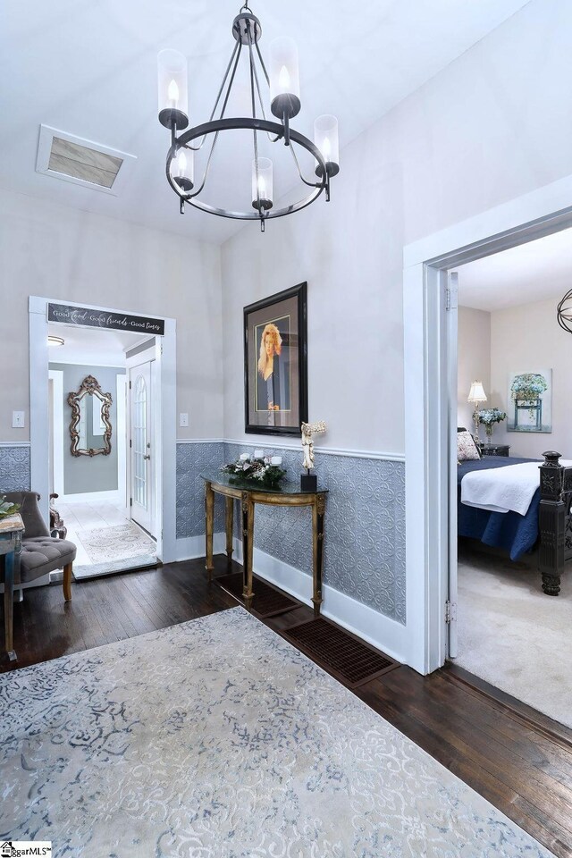 15 S Greenwood Ave, Ware Shoals, SC 29629 - foyer featuring wood finished floors, a chandelier, a wainscoted wall, baseboards, and visible vents